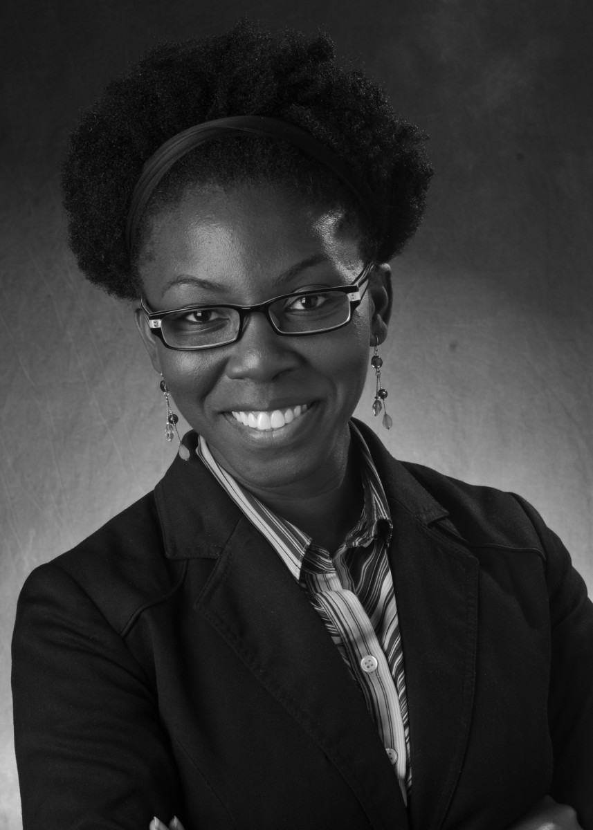 Headshot of Dr. Amma Y Gartey-Tagoe Kootin who is wearing a blazer, glasses and striped collared shirt